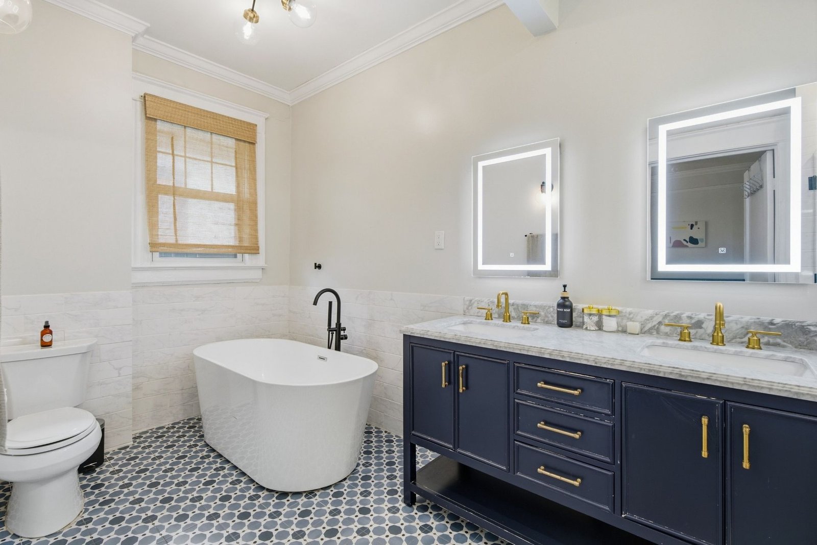 Spa style primary bath with freestanding soaking tub and double vanity