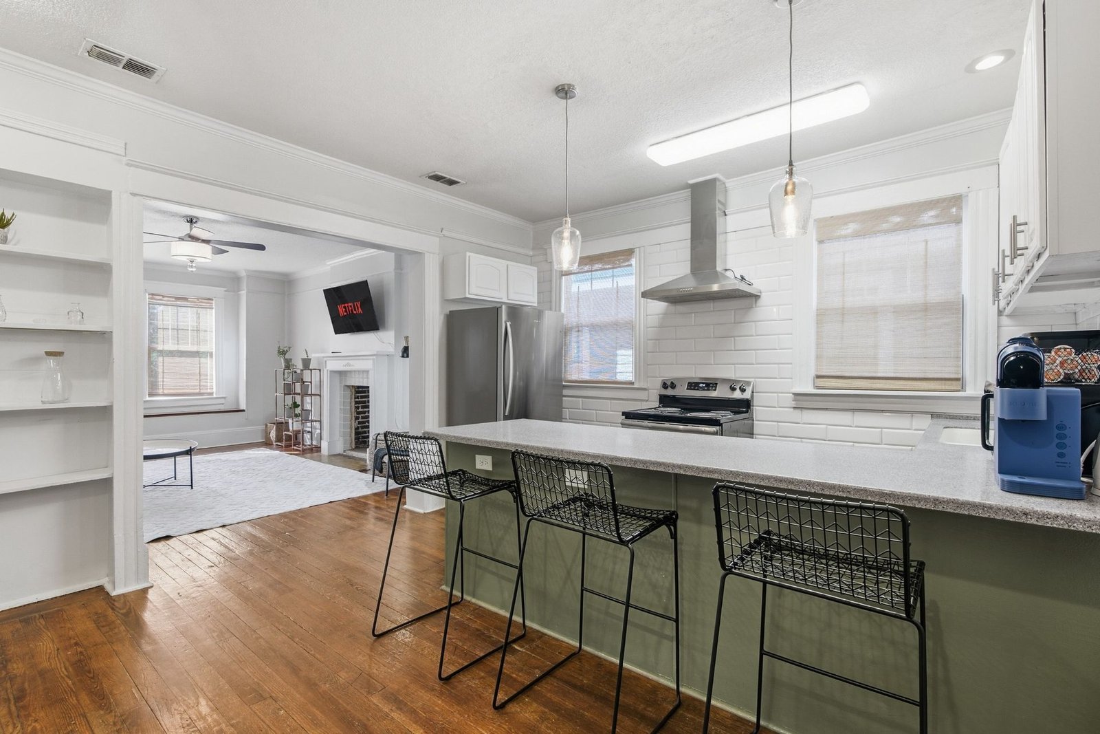 Kitchen with stainless appliances and range hood