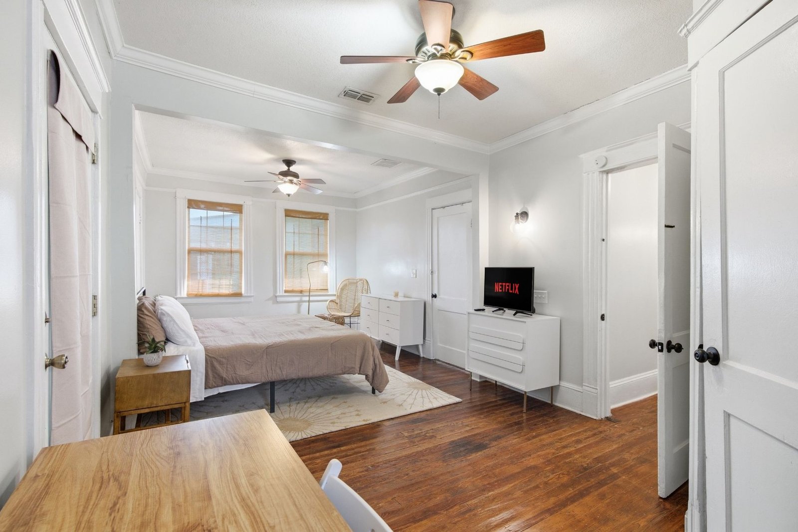 Primary suite with smart TV, desk and dresser