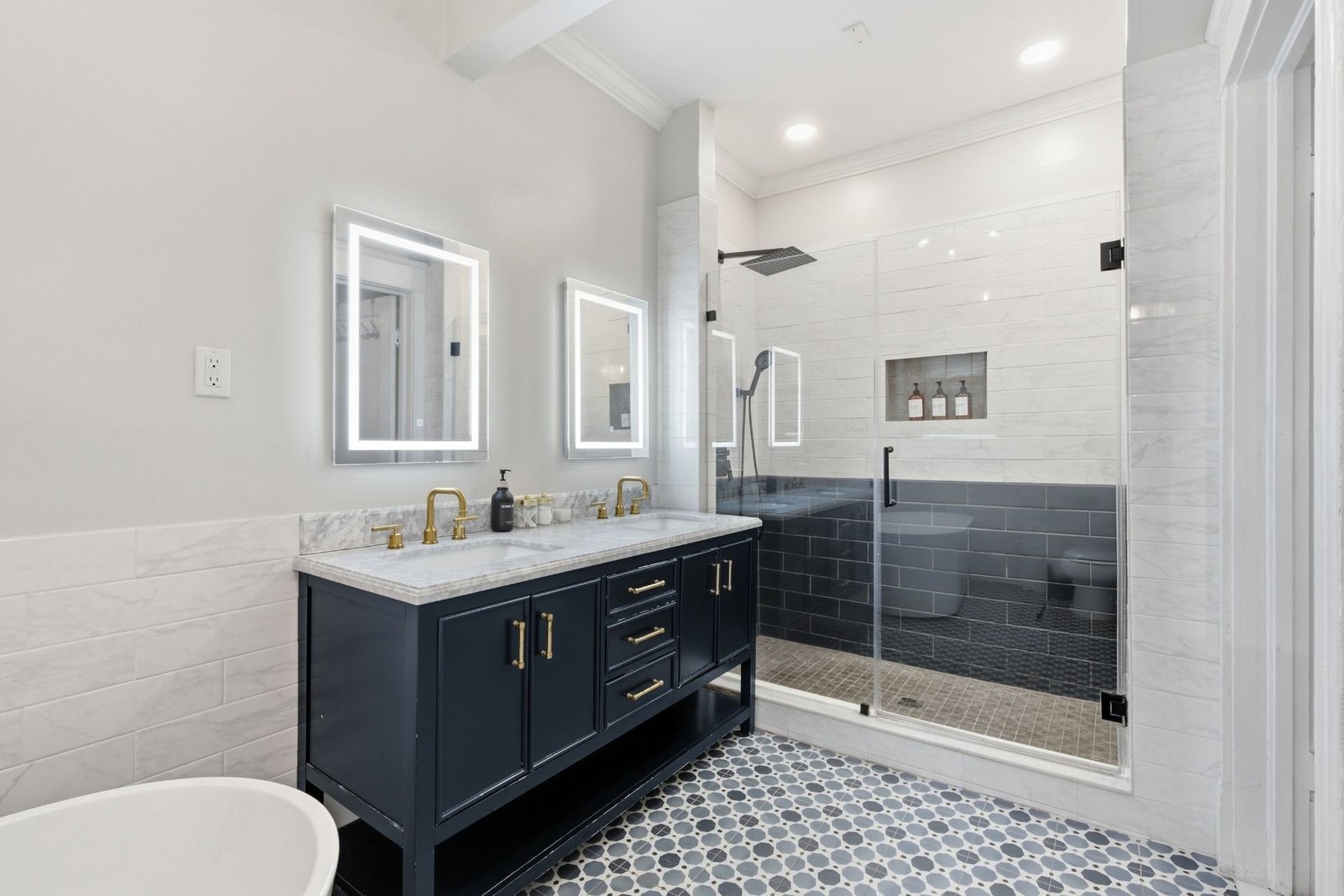 Glass walk in shower and lighted mirrors